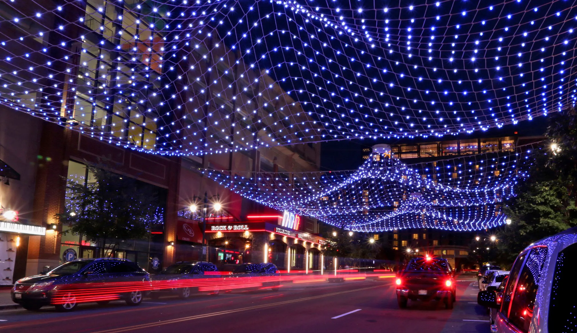 Looking down Fleet Street under the sculpture, traffic passing beneath the waves of light