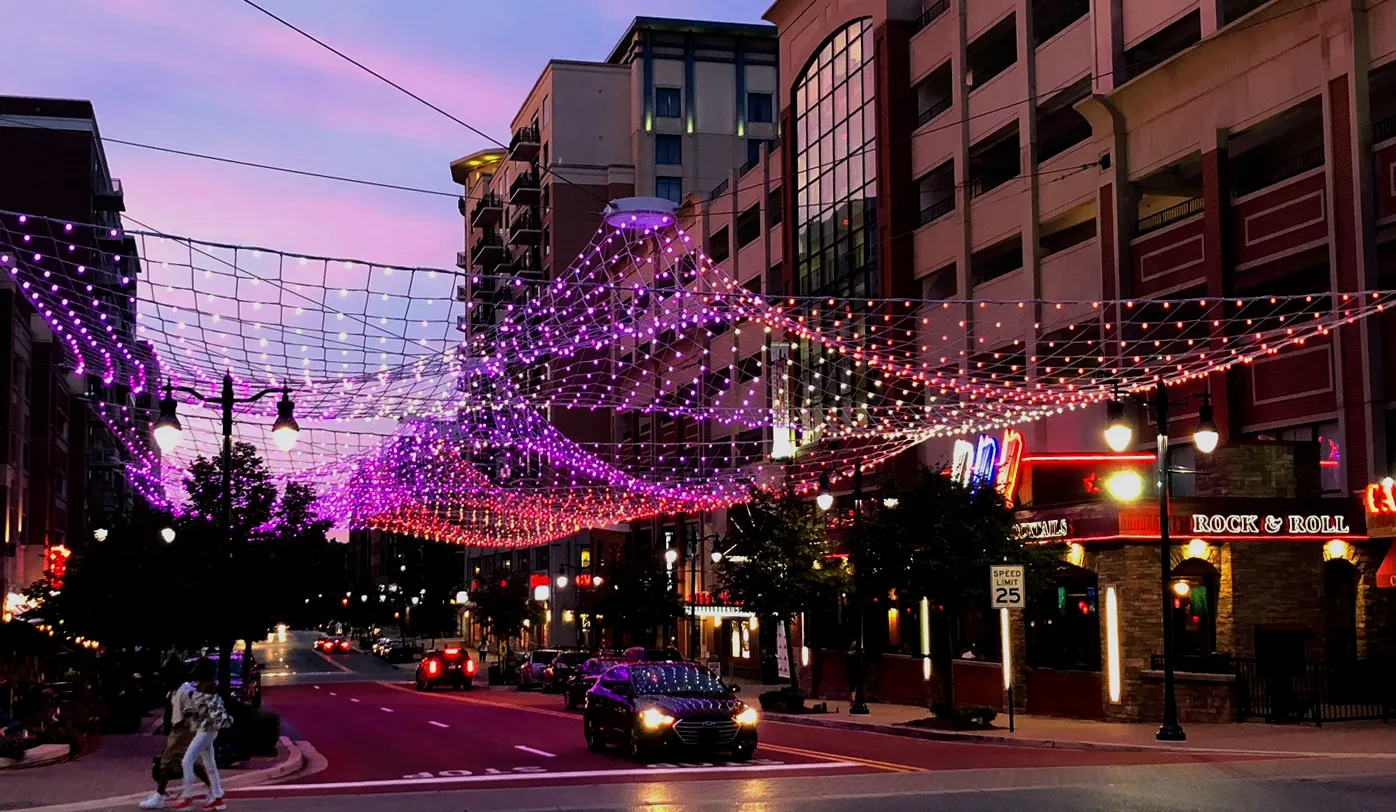 The sculpture at dusk, pink and violet against the evening sky